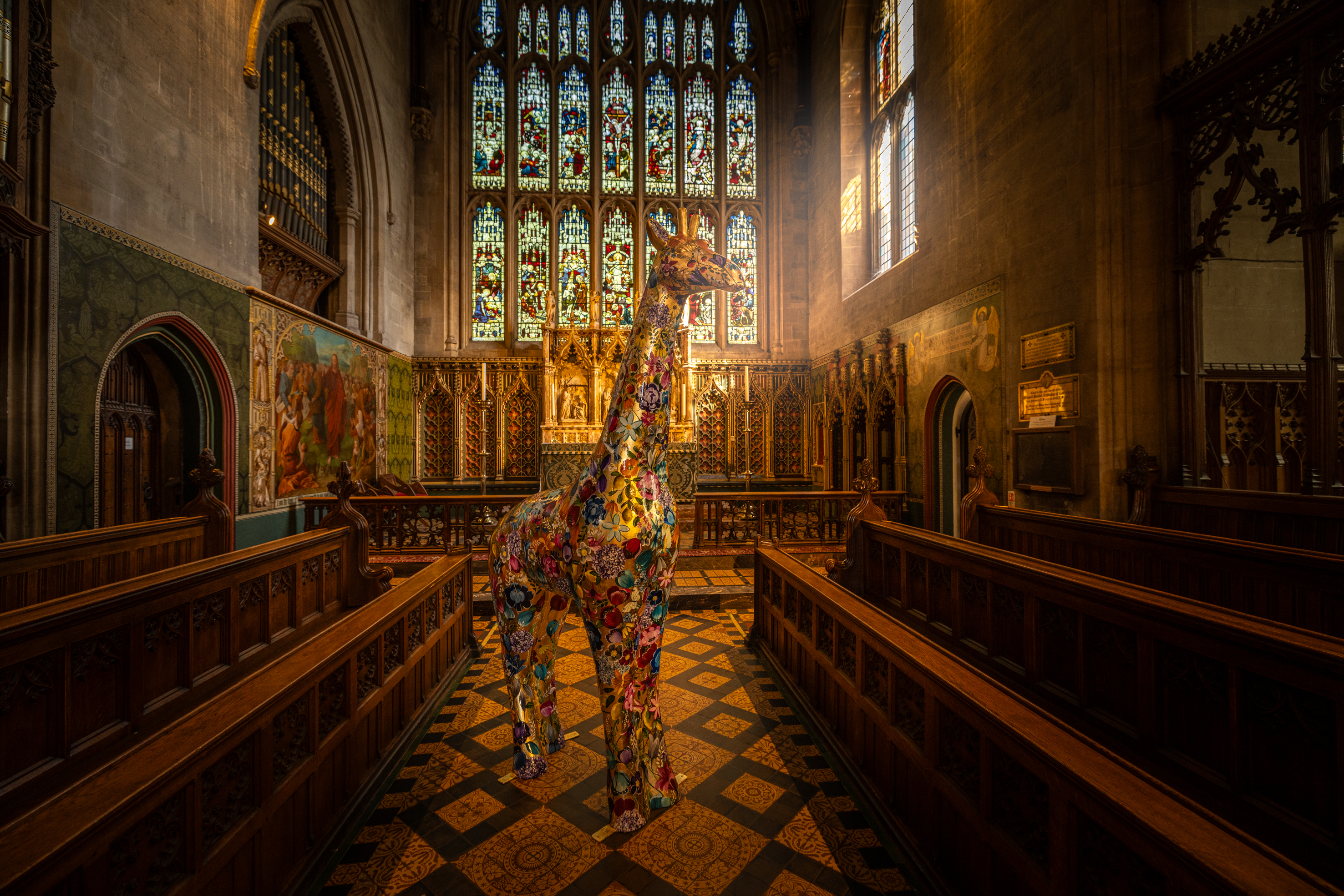 Fleur by Becky Smith. Giraffe in Croydon Minster with the sun shinning through the windows.