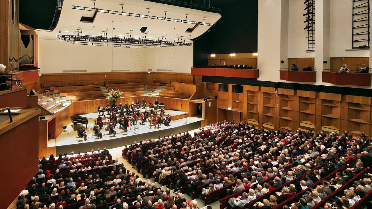 Fairfield Halls, Concert Hall. London Mozart Players orchestra on the concert hall platform with audience watching.