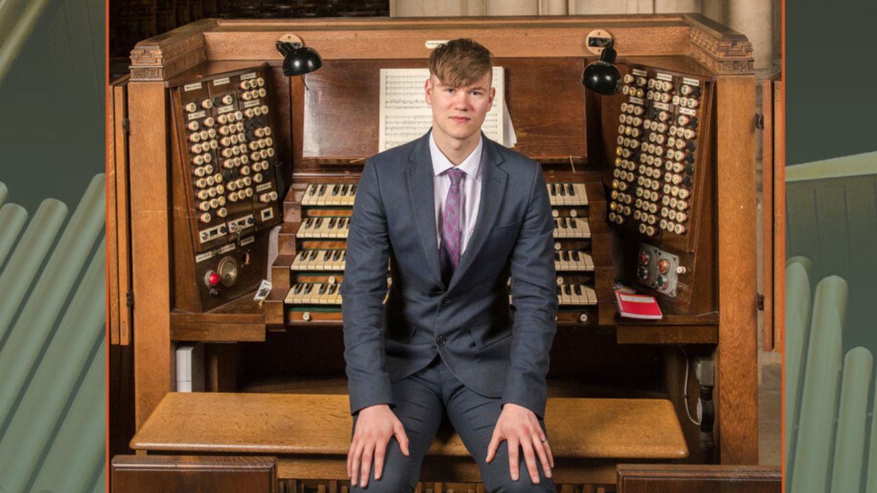 Photo of Mark Walters sitting on the bench in front of the Fairfield Halls organ.