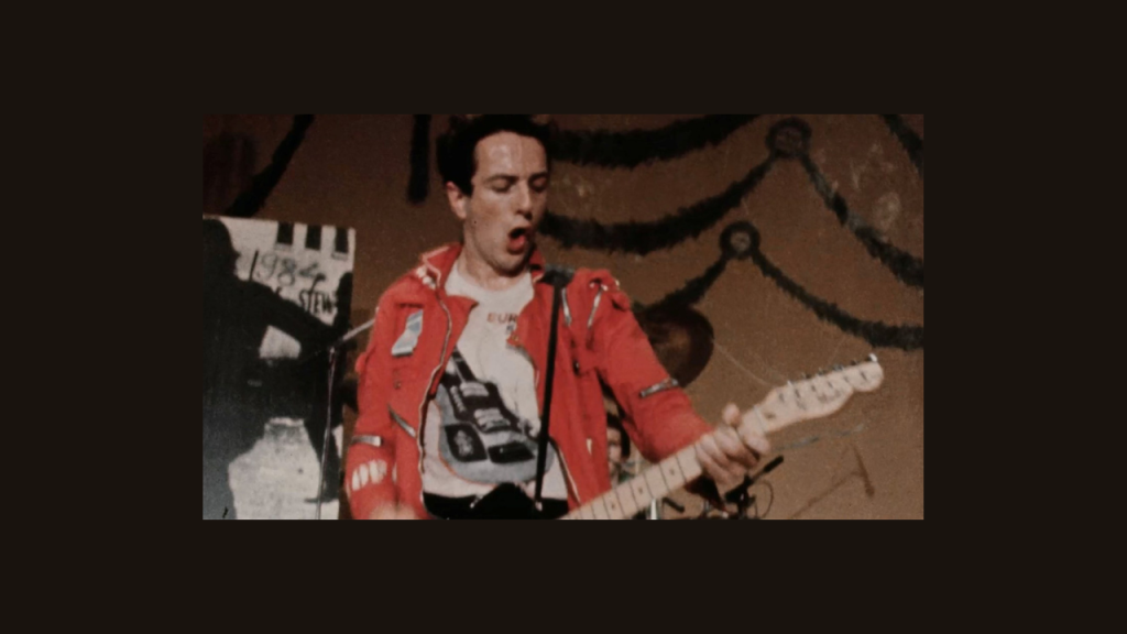 Photo from Punk in London. A man playing guitar.
