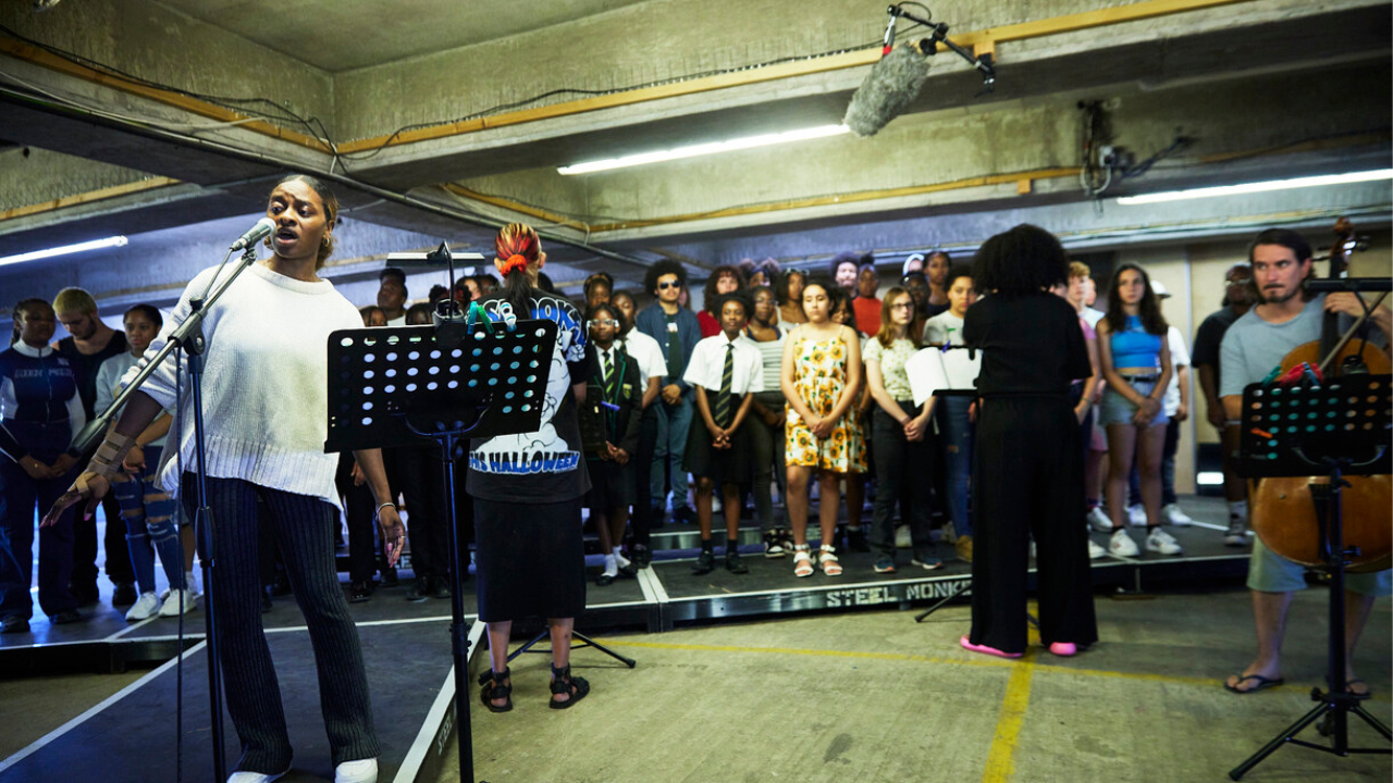 Young people performing on a flat stage.