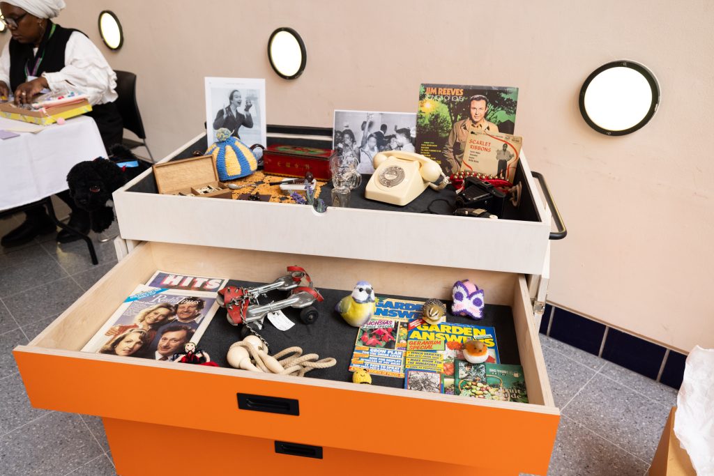 A chest of drawers displaying a collection of objects