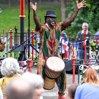Cheikh Diop and an African drum performing at a bandstand
