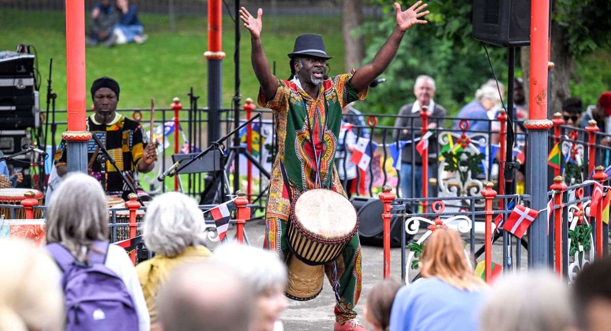 Cheikh Diop and an African drum performing at a bandstand