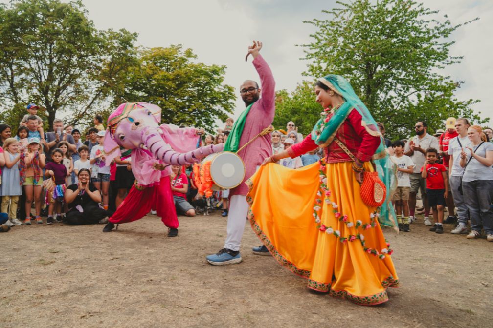 A kathak dancer, elephant puppet and dhol drummer
