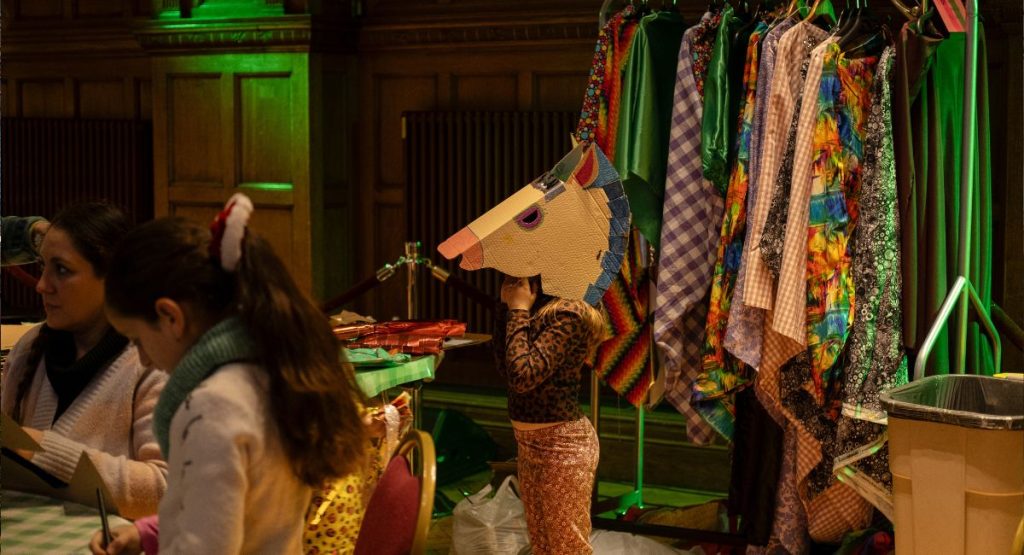 A child wearing a handmade horse head
