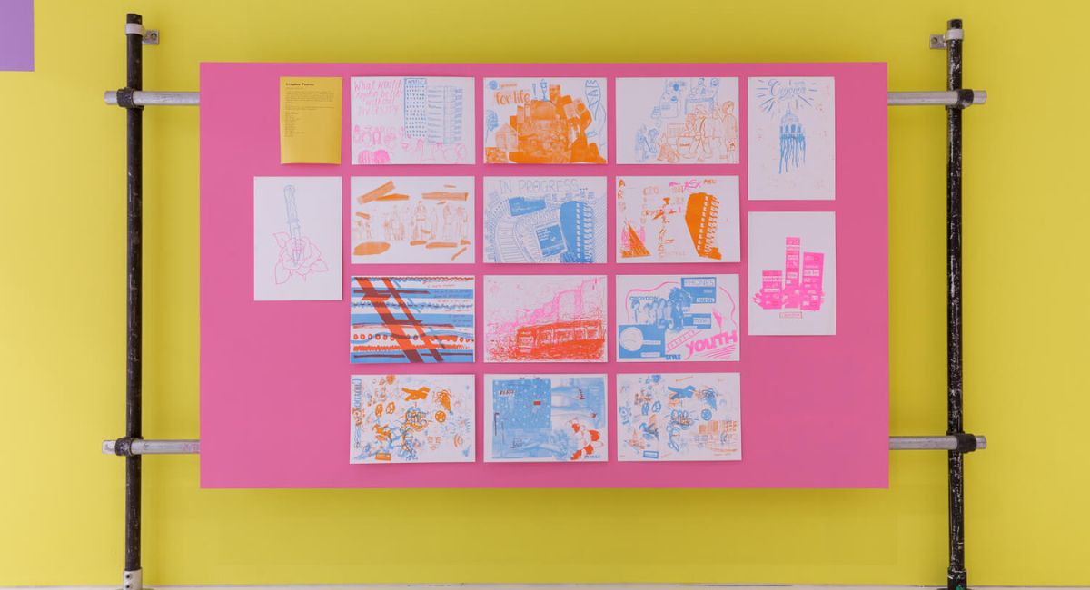 A display of artworks on a vibrant pink and yellow backdrop