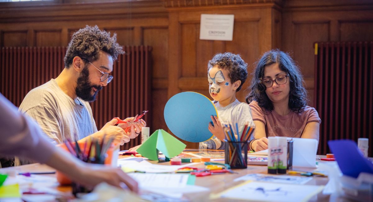 A family taking part in a craft workshop