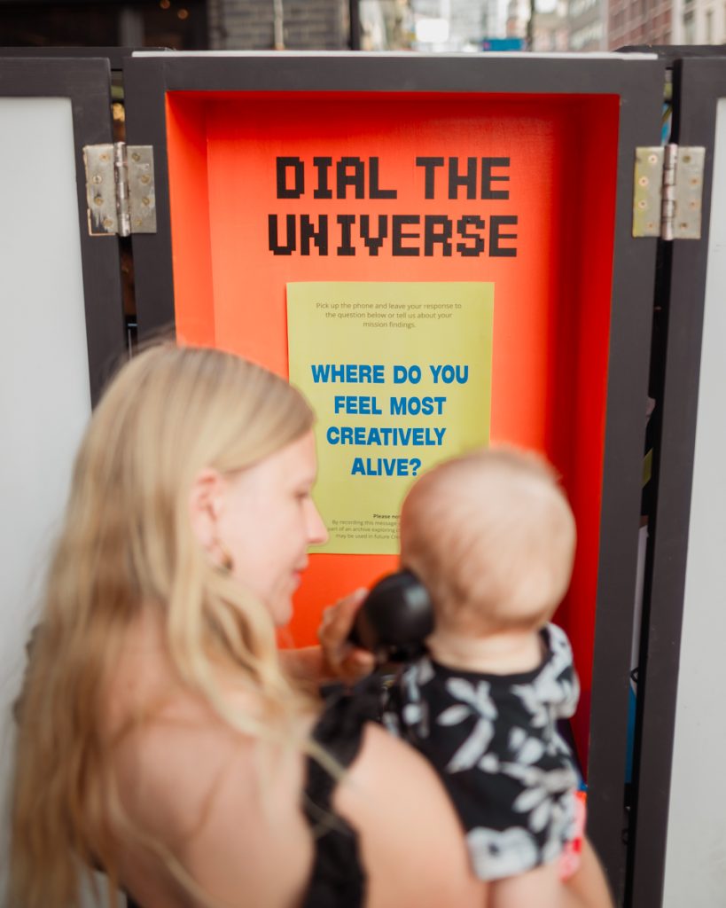 A baby holds the telephone on the Rover